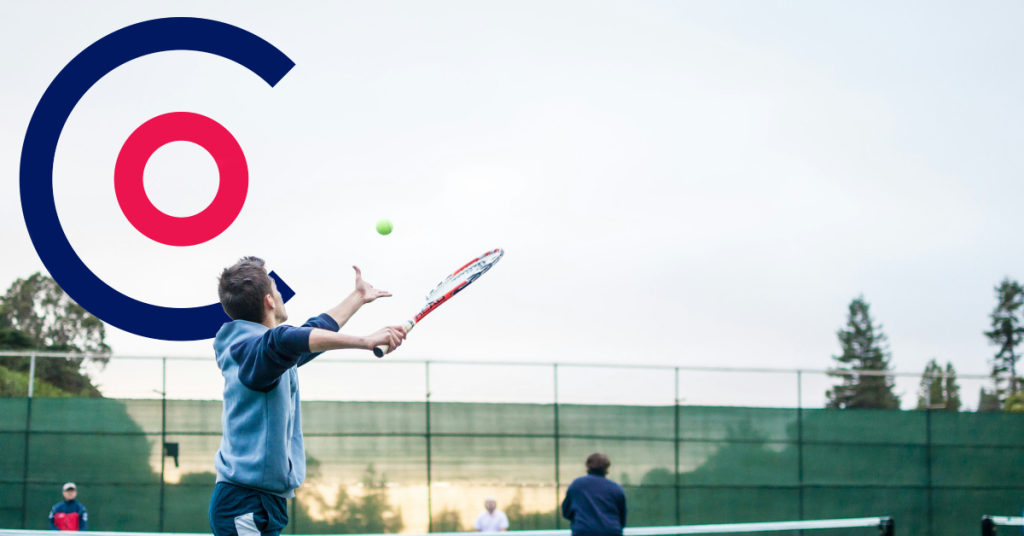 Man playing tennis with Coordinate Sport Logo in the background